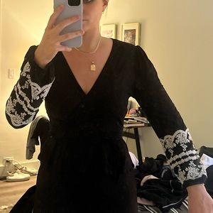 Black wrap top with white detailed sleeves